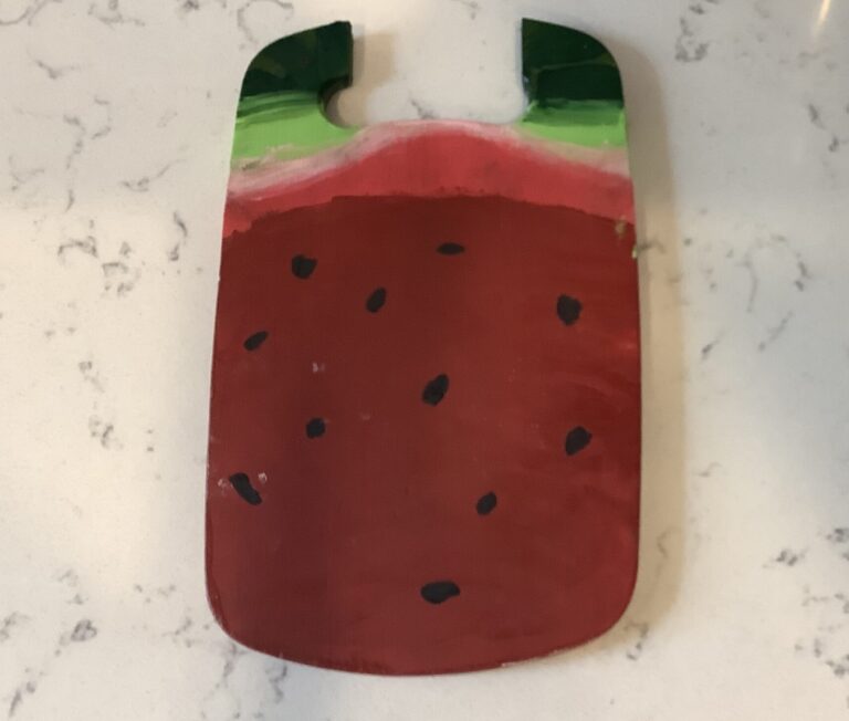 Broken cutting board painted as a watermelon.