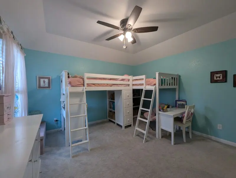Two loft sided top bunks with shelfs and tow desks with a matres and stuffies.