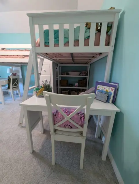A top bunk ( The back ) with a desk under it.